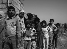 Refugees in line for supplies at a Minervan community